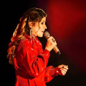 Woman in red dress holding microphone