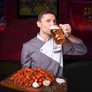 Chef holding beer and seafood platter