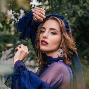 Woman in blue attire outdoors.